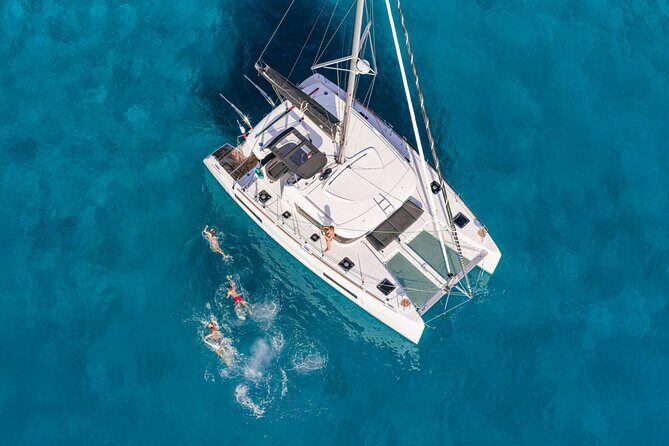 Catamaran Day & Sunset Cruises with meals Drinks and transportation - Rhenia’s 2-hour swim and snorkel stop (this is the heart of the day)
