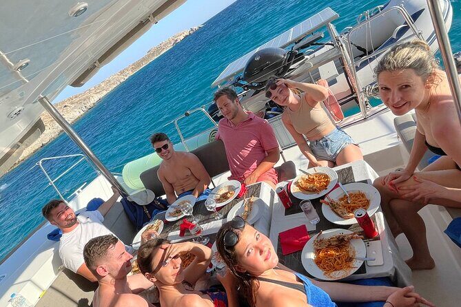 Full Day Discovering Mykonos Delos Renia Tour by Boat - Delos-area anchorage: swimming, SUP, snorkel, and jump-offs